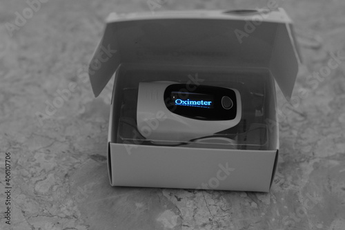 a closeup for a fingertip pulse oximeter that measures the oxygen saturation of the blood and the pulse rate for Covid 19 pandemic , Corona virus measurement of oxygen saturation level 