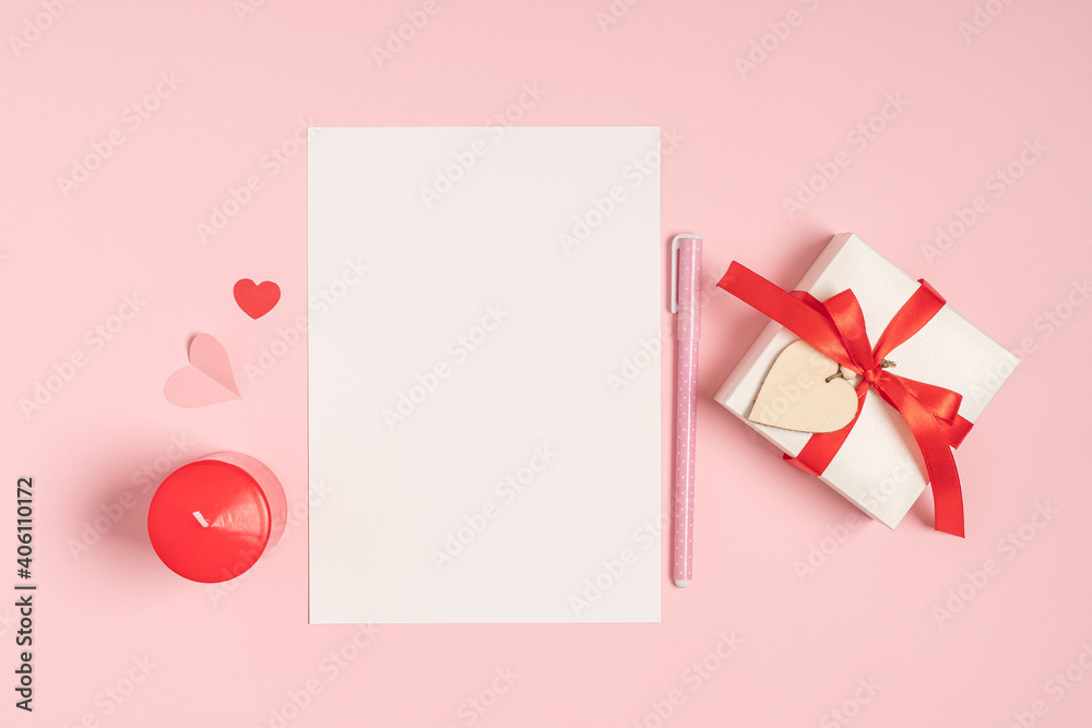 Desktop blank paper note pad. Flat lay of pink pastel working table background with Valentine gift, letter, heart shape and decoration. Top view, mock up greeting card Desktop blank paper note pad. Flat lay of pink pastel working table background with Valentine gift, letter, heart shape and decoration. Top view, mock up greeting card