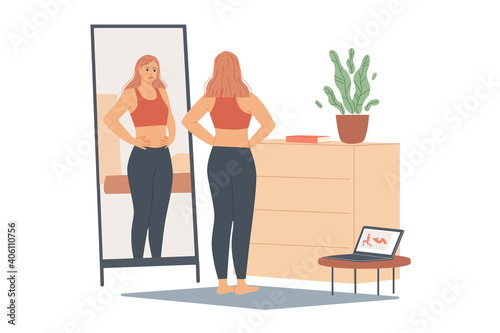 Woman not happy with her weight, she looks at her belly and waist, stands in front of a mirror and looks at her body after training.