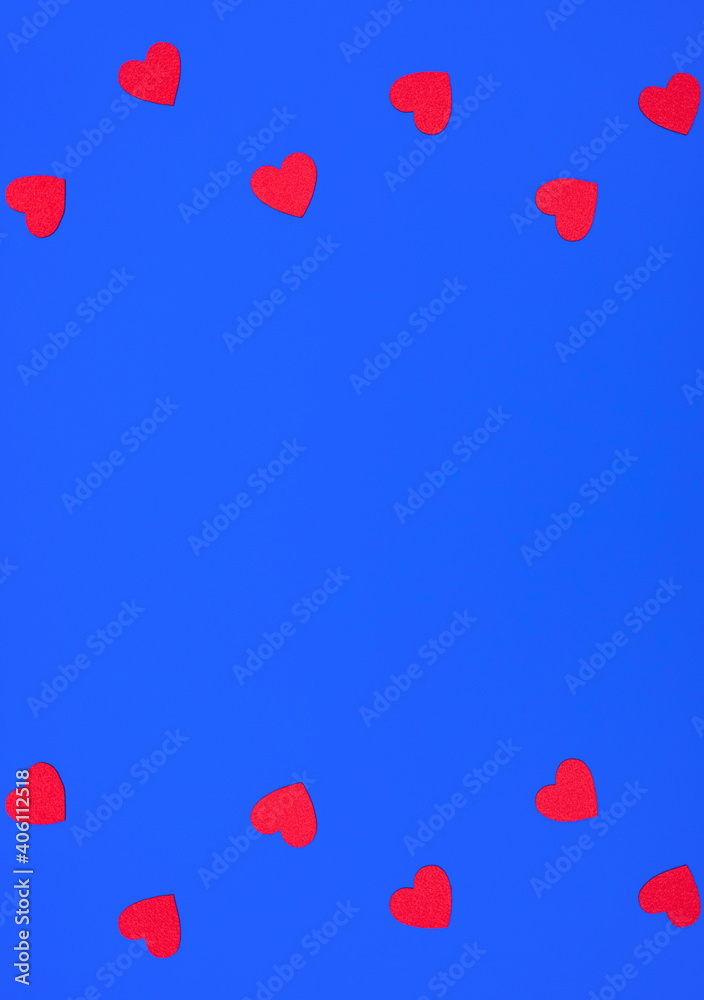 Valentine scene with felt red hearts on blue background. Love concept. Minimal flat lay style with copy space. Greeting or invitation card.