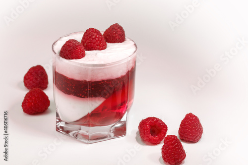 White delicious yogurt dessert with raspberry berries, jam and raspberry jelly. Healthy Breakfast, light snack. The concept of healthy eating.