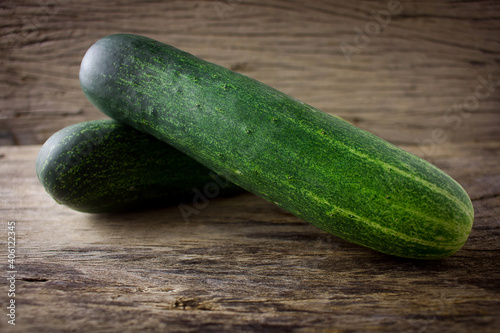 Fresh cucumber on rustic wooden background.
