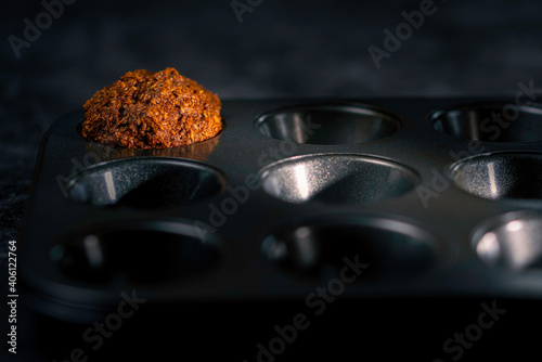 Spotlight on single homemade muffin in cooking tray