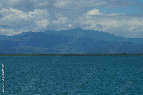 A view of the blue sea against a mountain backdrop
