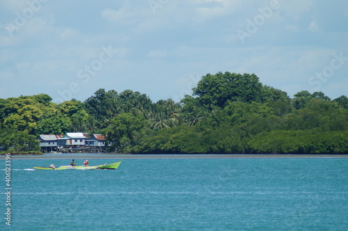 view of blue sea by boat and island during daytime © Syamsuddin