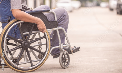 disabled man on wheelchair and sister walking in the park