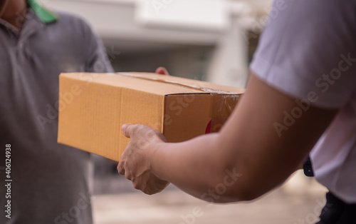 Delivery man by sending box of parcel to customers service at home © pirom