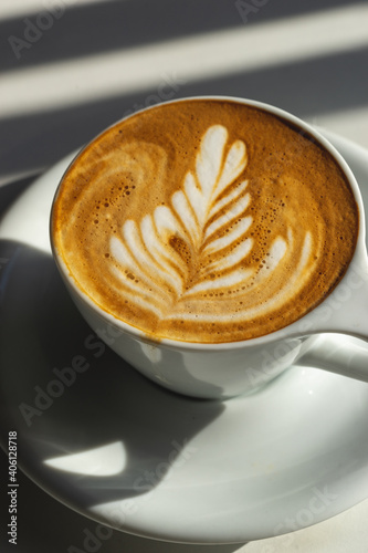 cup of coffee latte art with window light
