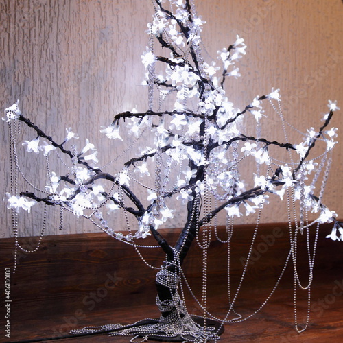 Indoor small decirative bare tree with lighted branches, european winter interior design photo