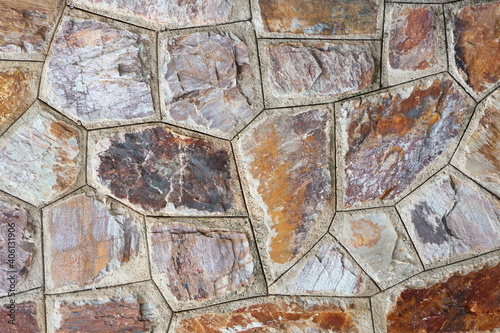 Textured of surface stone wall for background. Tone orange, brown and red color same rust.