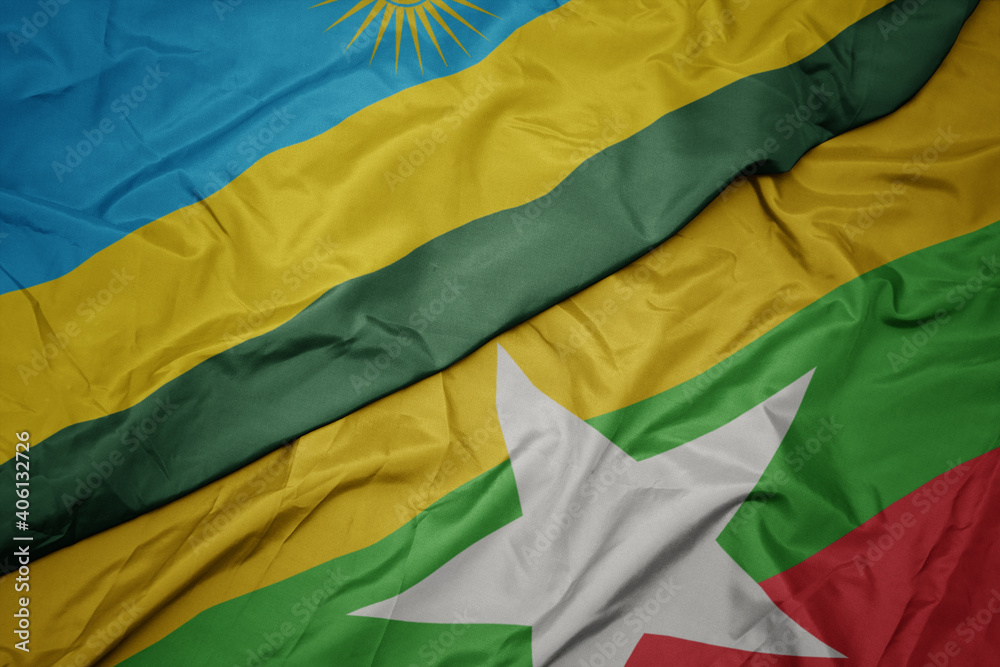 waving colorful flag of myanmar and national flag of rwanda.