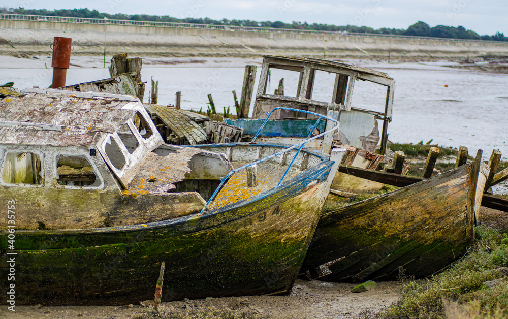 Vendée, France; January 15, 2021: Prows of old abandoned boats in the boat cemetery of the island of Noirmoutier.