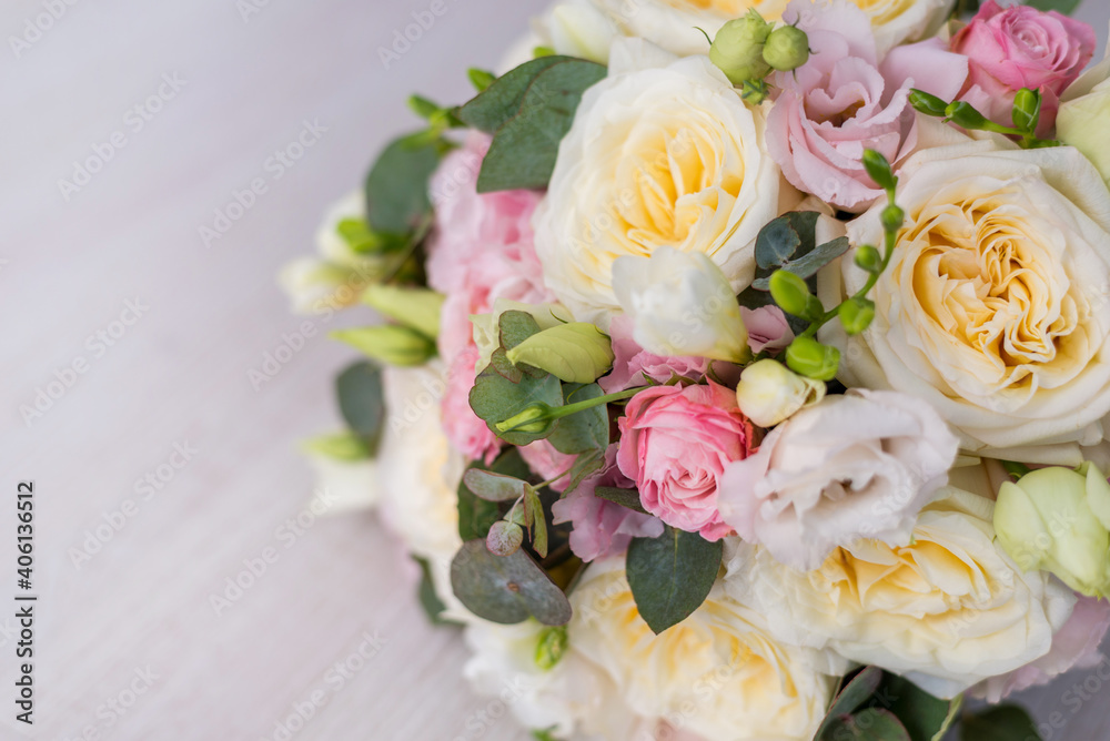 close-up of a beautiful bouquet on a gray background. Soft pink roses and cream, yellow close-up of a beautiful bouquet on a gray background. Soft pink roses and cream, yellow