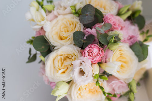 beautiful bouquet on a gray background. Soft pink roses and cream, yellow