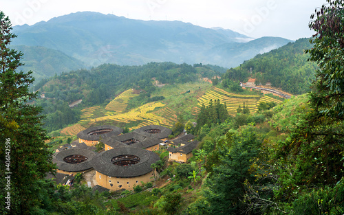 FUJIAN, CHINA – OCTOBER 11, 2019:The tulou are ancient earth dwellings of the Hakka people(TianlouKeng cluster), Fujian province, China. photo