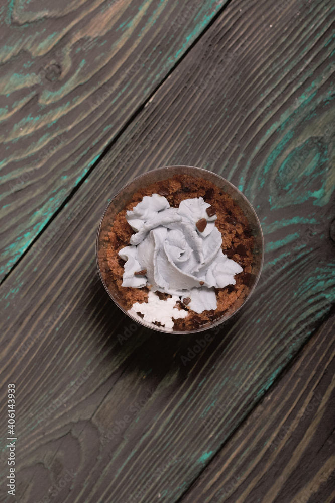 Biscuit trifles with chocolate and cream cheese. Decorated with mastic snowflakes. On pine boards.