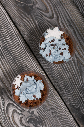 Biscuit trifles with chocolate and cream cheese. Decorated with mastic snowflakes. On pine boards.