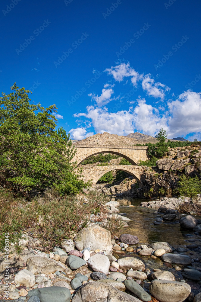 Monte Albanu and the bridge Ponte Altu over River Golo in the Albertacce village. The rocky granite gorge Scala di Santa Regina Niolo valley, Corsica, France