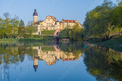 View of the Nesvizh Castle from the side of the Castle Pond on a sunny May morning. Belarus