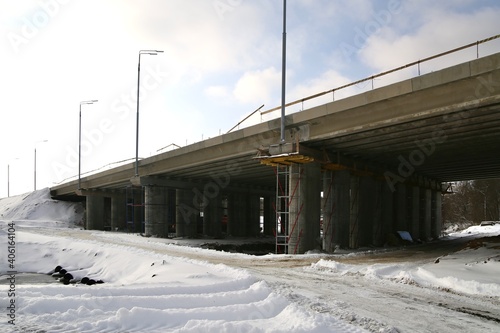 Landscape with a road bridge under construction in winter.