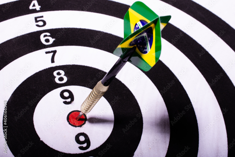 Dart with Brazil flag spiked in the center of black and white target. Selective focus. Dart with Brazil flag spiked in the center of black and white target. Selective focus.