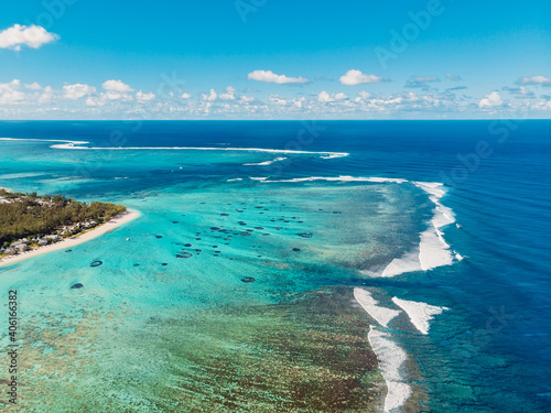 Fototapeta Naklejka Na Ścianę i Meble -  One eye beach in Mauritius. Underwater waterfall and waves in ocean. Aerial view of Le Morne