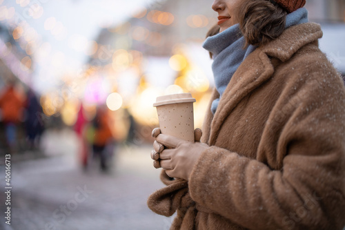 Woman with takeaway coffee on the Christmas market