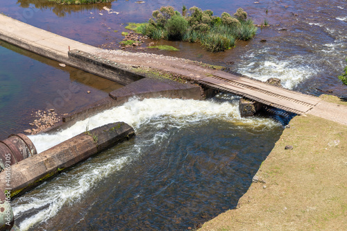 Blang dam with Cai river and road photo