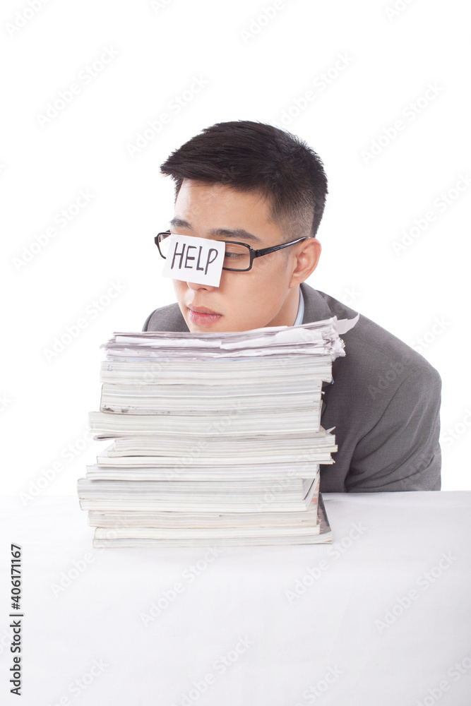 Portrait of young bisinessman leaning on stack of files Portrait of young bisinessman leaning on stack of files