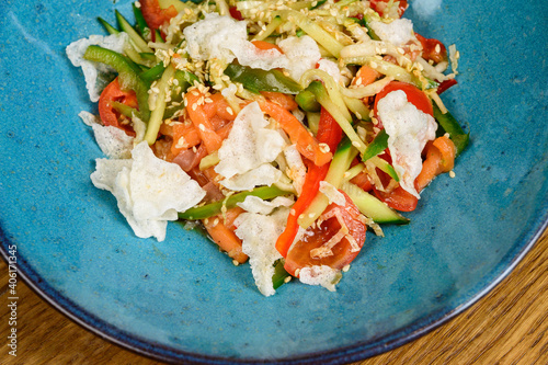 Vegetable vegetarian salad with tomatoes, peppers and onions on wooden table. photo