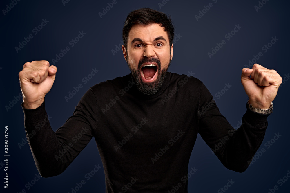 Cheerful, ambitious good-looking bearded businessman in high neck sweater, yelling from happiness, rooting for team, fist pump and stare camera accomplished, winning competition, achieve goal