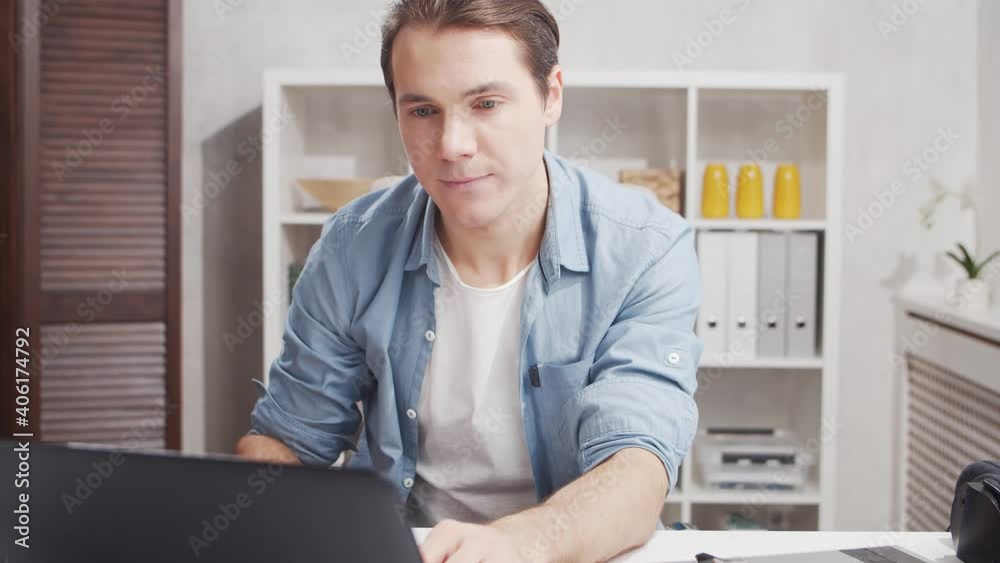 Workplace of freelance worker at home office. Young man works using computer. Remote job concept. Workplace of freelance worker at home office. Young man works using computer. Remote job concept.