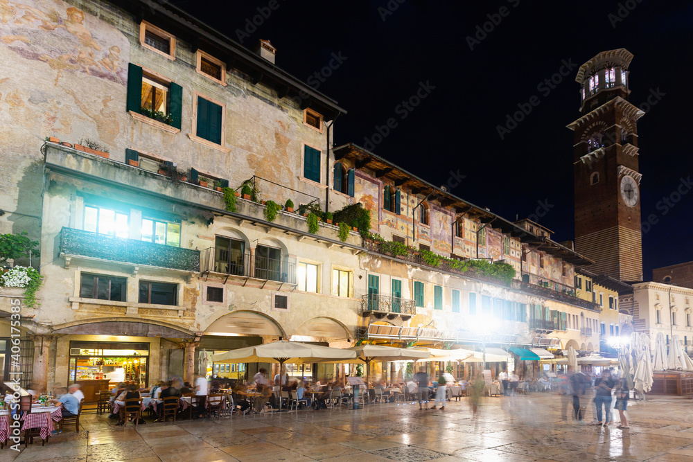 Picturesque cityscape of busy central streets of Verona in night lights, Italy.