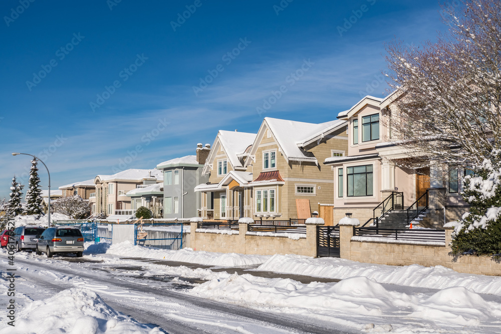 Street of brand new luxury houses on blue sky background in winter Street of brand new luxury houses on blue sky background in winter