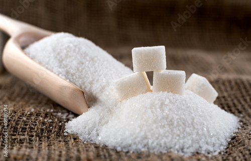 Bits of refined sugar are scattered across the fabric. Scoop for bulk products. Sugar