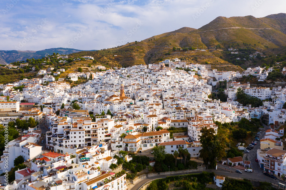 Aerial view of Competa, small picturesque town in foothills of La Maroma mountain on sunny fall day, Spain