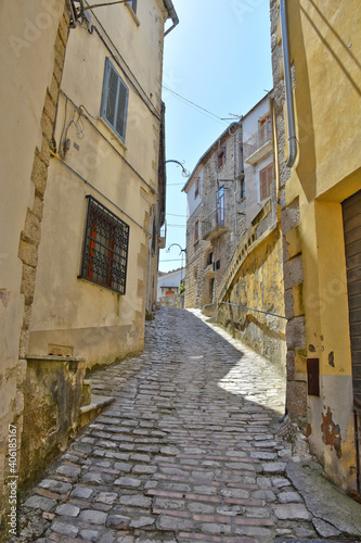 A narrow street between the stone houses of Morcone  an old town in the province of Benevento  Italy. 
