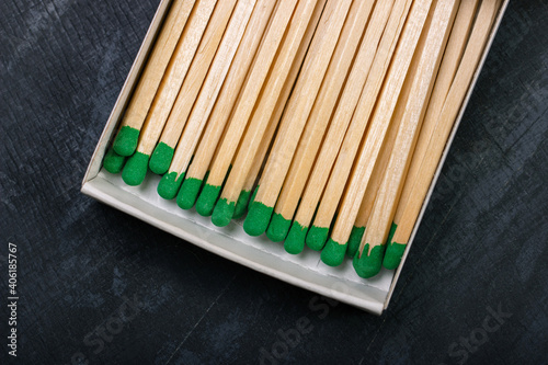Long wooden matches with green gray in a box