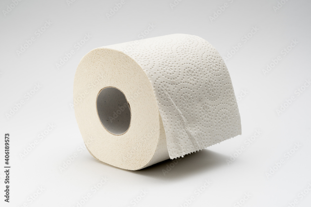White toilet paper roll on a neutral white background. Full bathroom tissue out of recycled material. White toilet paper roll on a neutral white background. Full bathroom tissue out of recycled material.