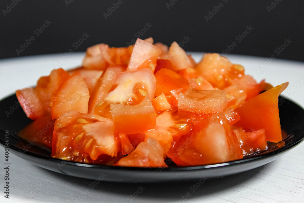 Ripe tomatoes on a plate, which are finely chopped. Ripe tomatoes on a plate, which are finely chopped.