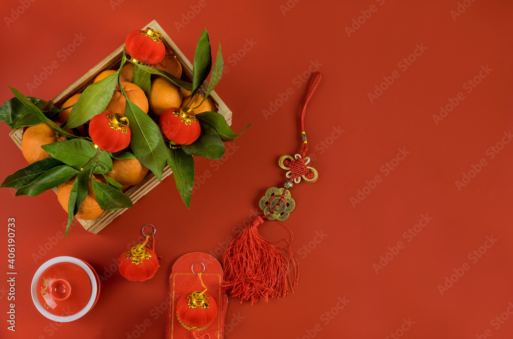 Decorations of accessories in Chinese New Year decoration festival traditional container mandarin oranges on a red background