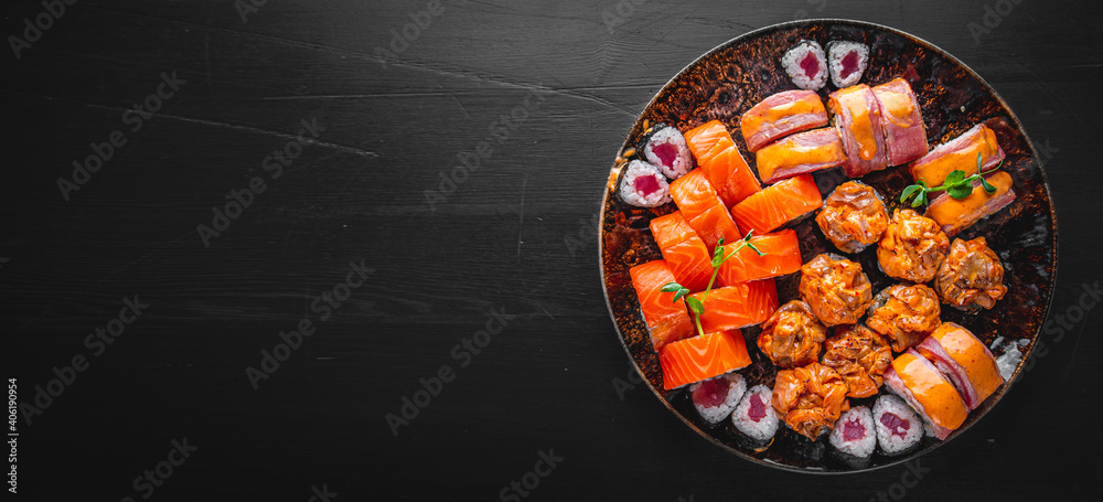 set of sushi roll with salmon, avocado, cream cheese, cucumber, rice, tuna in plate on black background set of sushi roll with salmon, avocado, cream cheese, cucumber, rice, tuna in plate on black background