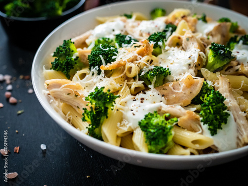 Fotomural Penne with roast chicken meat, broccoli, parmesan and cream sauce  on black wood