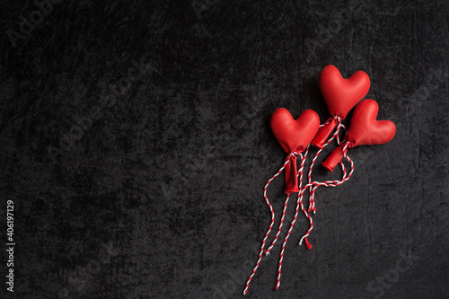 happy valentines day. red balloons in the form of a heart on a black background.
