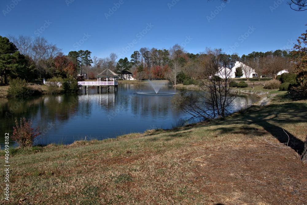 Fototapeta premium Fountain in a lake with a gazebo in the background