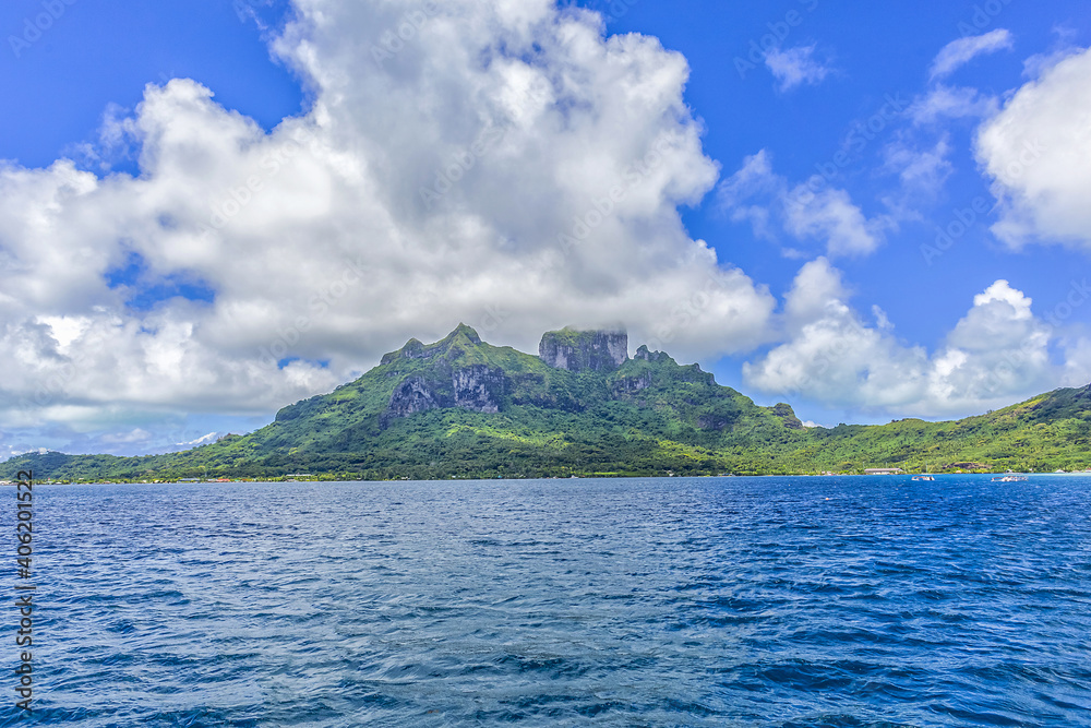 Tranquil tropical landscape: Island of Bora Bora in French Polynesia surrounded by a turquoise lagoon. Pacific Ocean.