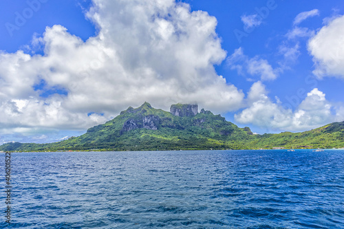 Tranquil tropical landscape: Island of Bora Bora in French Polynesia surrounded by a turquoise lagoon. Pacific Ocean.