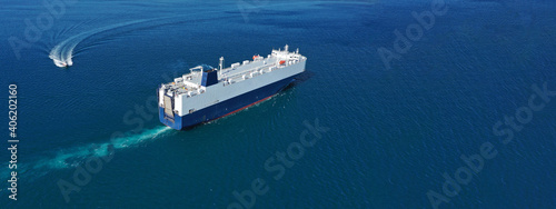 Aerial drone ultra wide photo of Large RoRo (Roll on-off) car transportation vessel cruising the Mediterranean deep blue sea