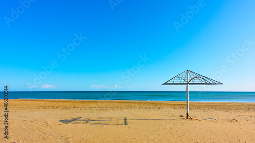 Sea and emply sandy beach with paraso photo