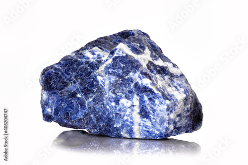 Amazing closeup macro of colorful blue veined sodalite mineral 
stone specimen isolated on white background. Beautiful blue natural raw rough rock